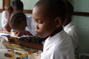 boy_reading_in_Tanzania_library